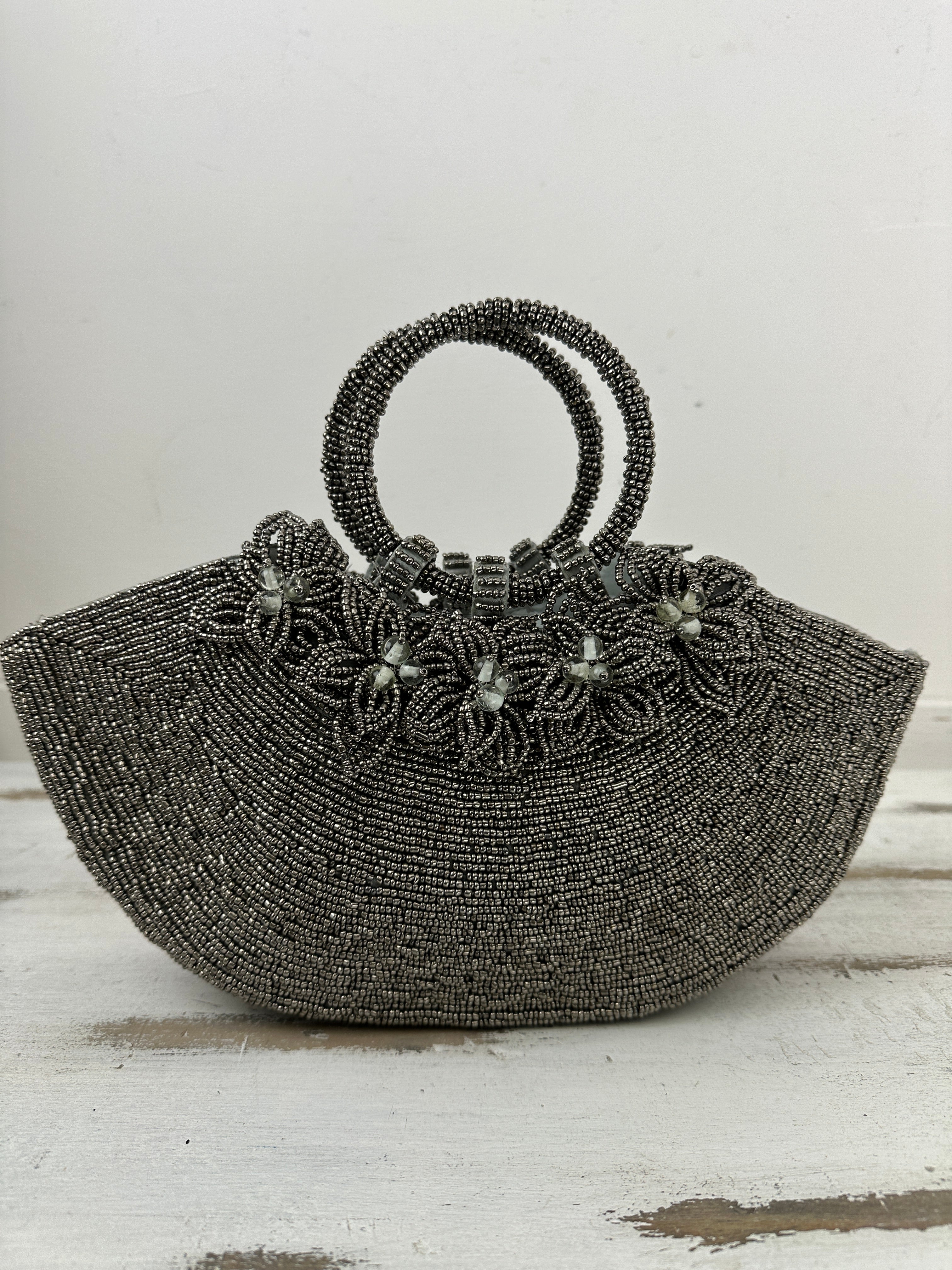 front view of beaded handbag with beaded flowers attached 