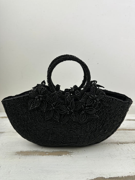 front view of beaded handbag with beaded flowers attached