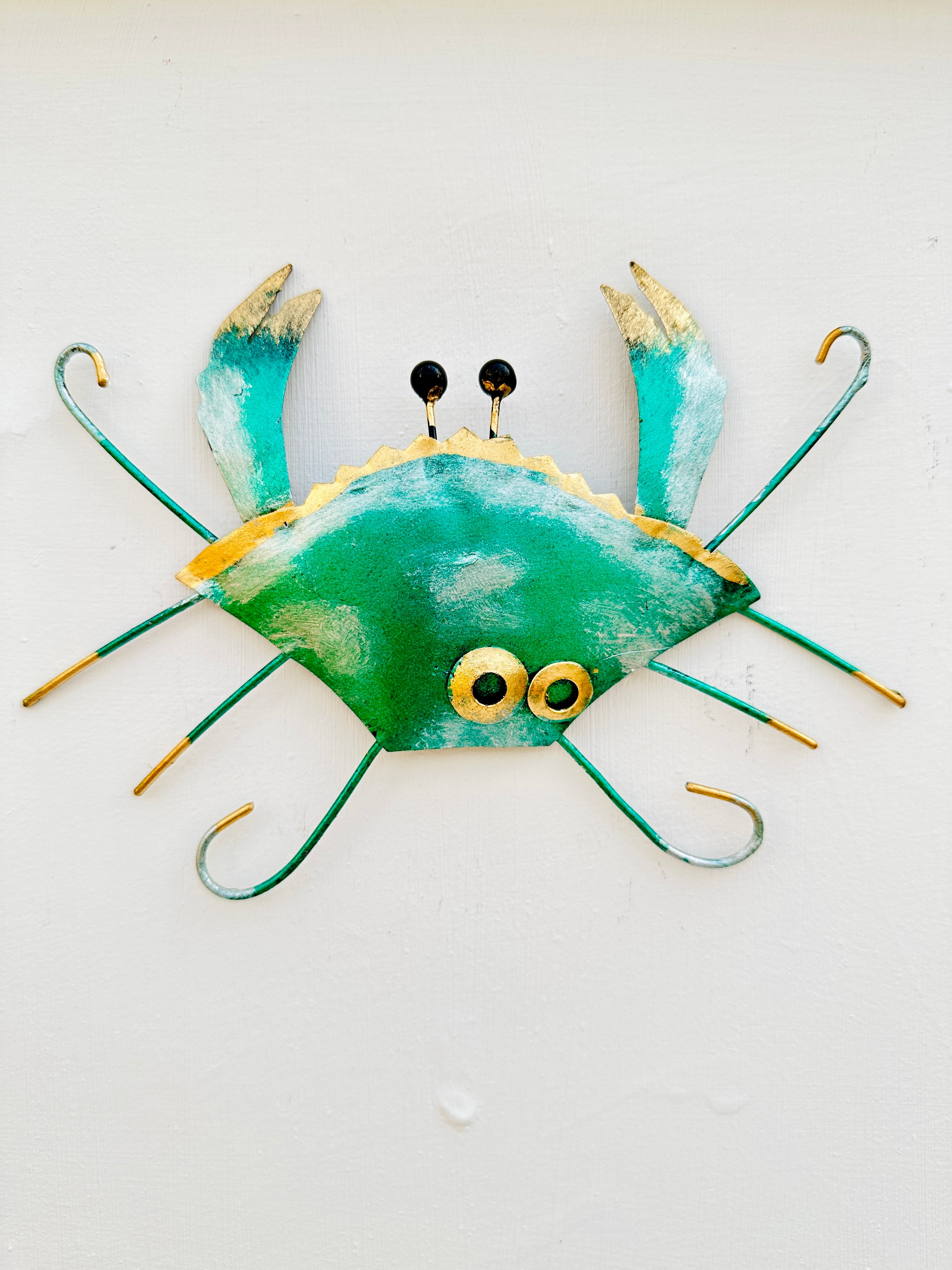 front view of metal crab in green