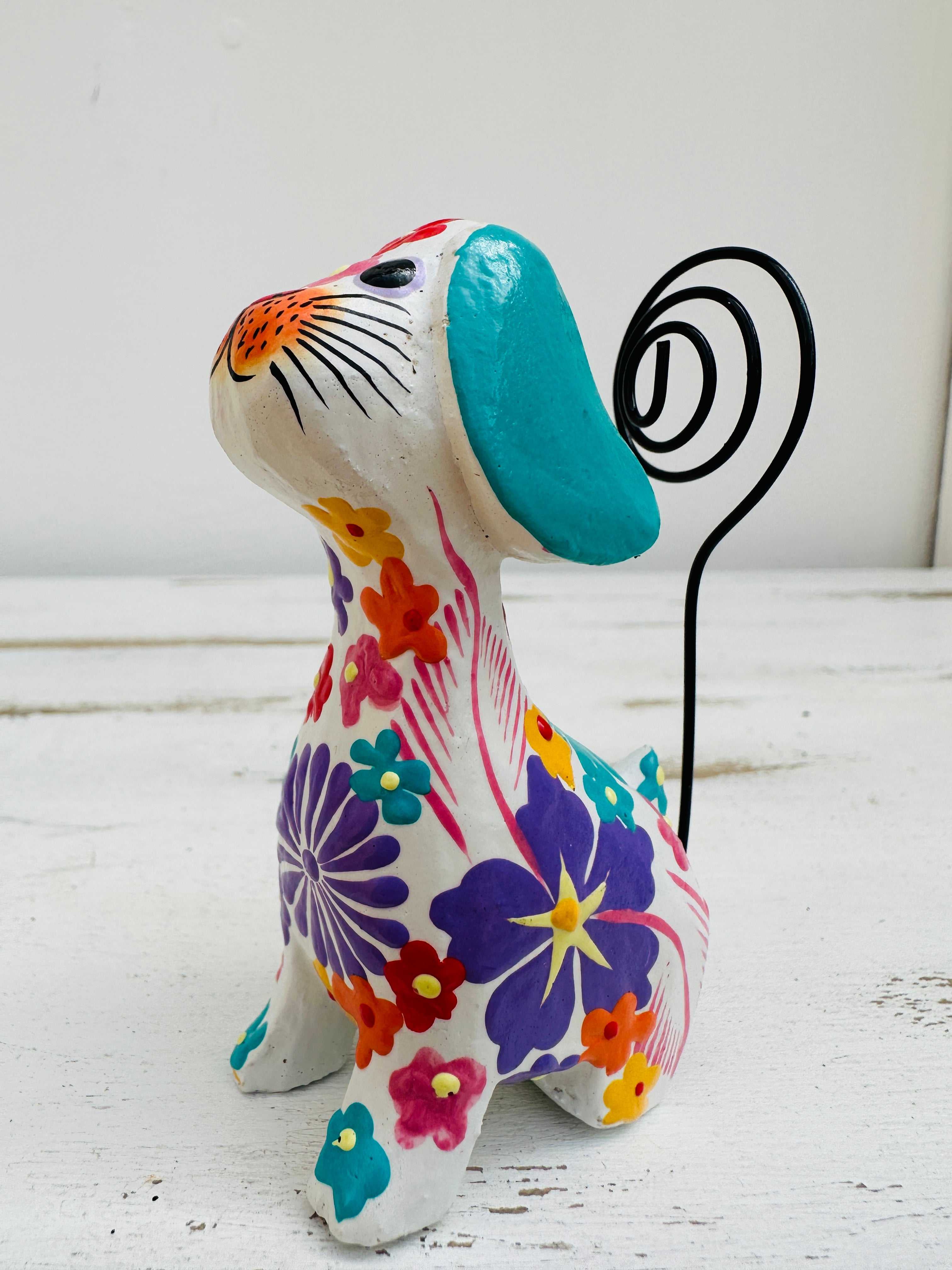 side view of wooden flower dog in white