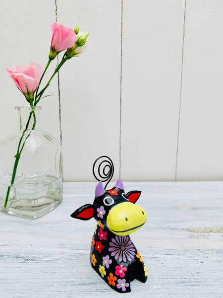 display side view of flower wooden cow in black