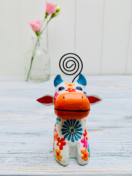 front view of wooden flower cow in white 