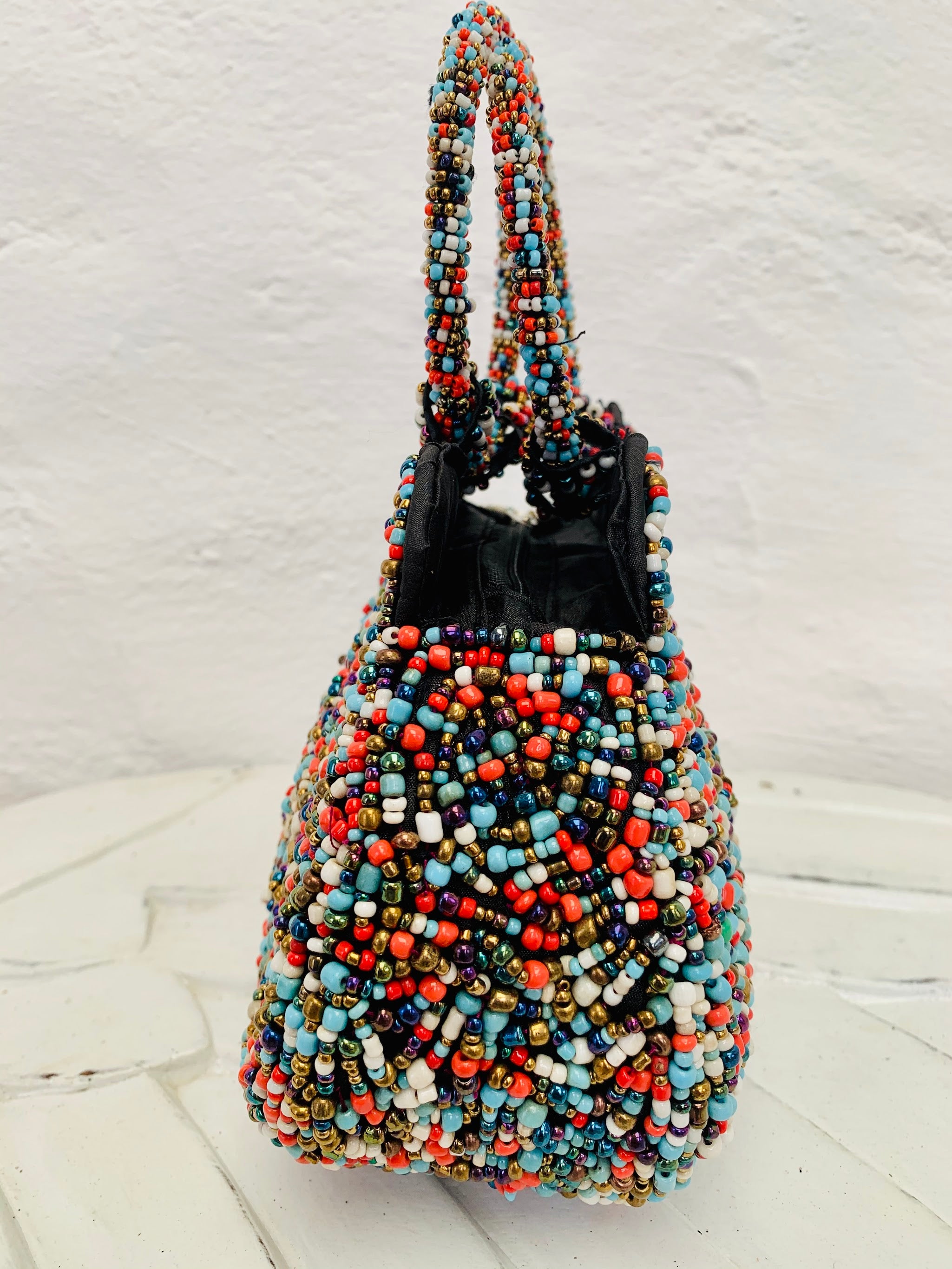 side view of beaded handbag in multi colours