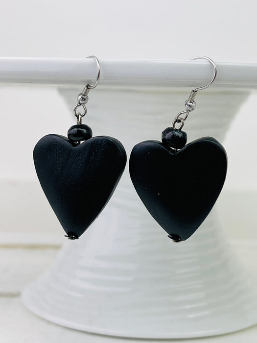 Black heart wood bead earrings with hook closure.