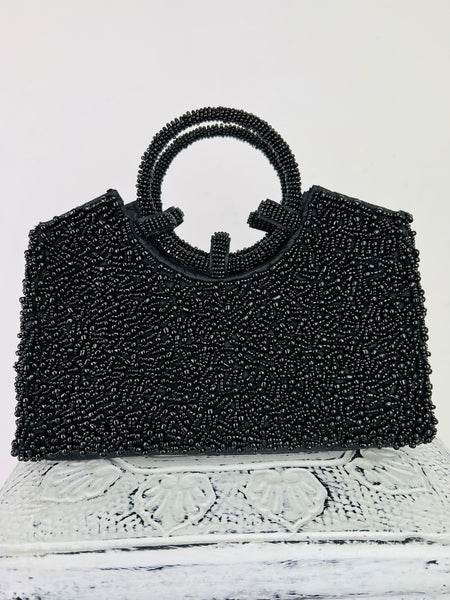 front view of black beaded bag on white background