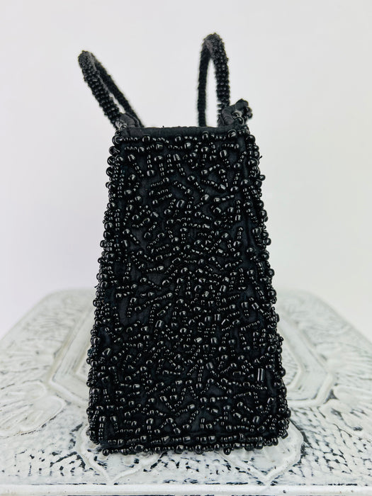 side close up of beaded black handbag