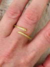 Delicate silver sleek snake ring with fine pave-style detailing and adjustable open band, displayed on a model.