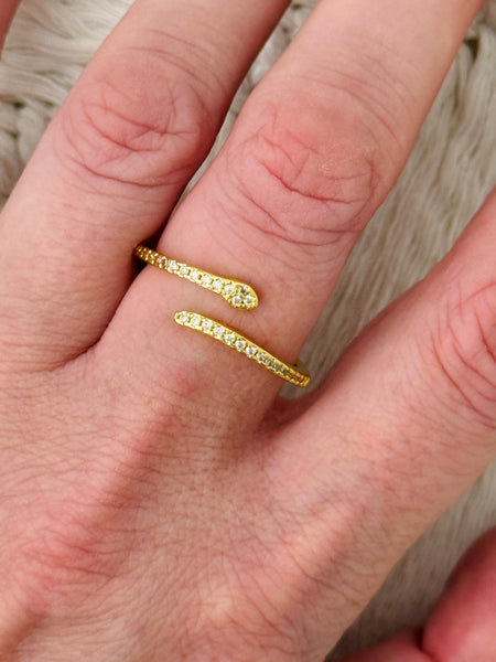 Delicate silver sleek snake ring with fine pave-style detailing and adjustable open band, displayed on a model.