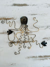 aerial back view of metal octopus with fish 