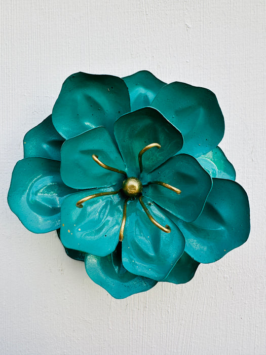 front view of metal poppy in turquoise