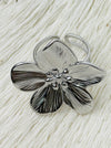 Adjustable silver-tone statement ring featuring a five-petal flower with textured detail, displayed on a white background.