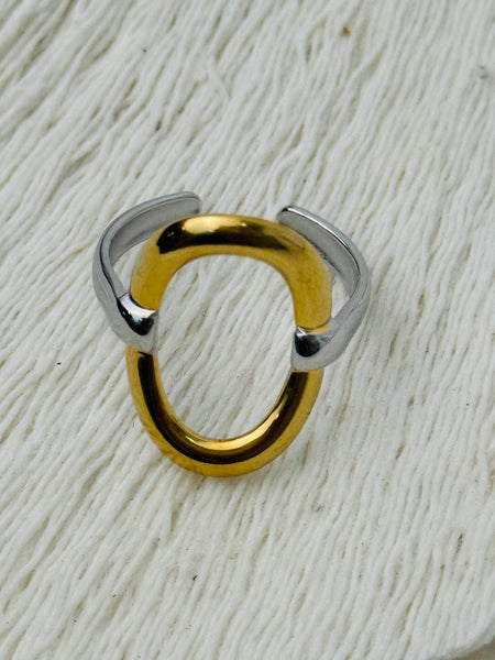 Two-tone open band ring with silver adjustable band and gold circular accent, displayed on a white background.