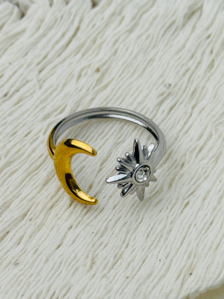 Moon and star open adjustable ring in gold and silver with crystal detail, displayed on a white background.