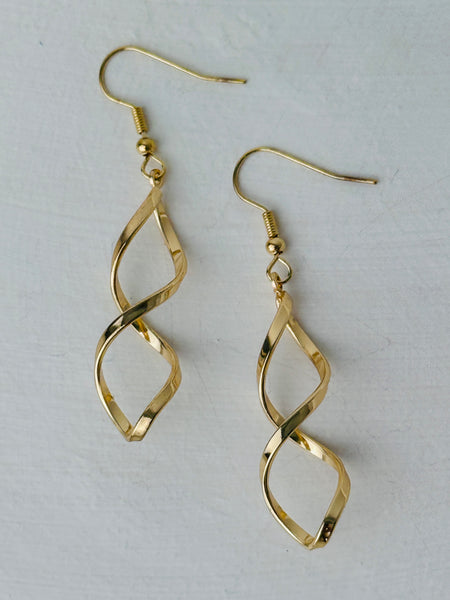 Elegant gold twist earrings with a modern spiral design, displayed on a white background.