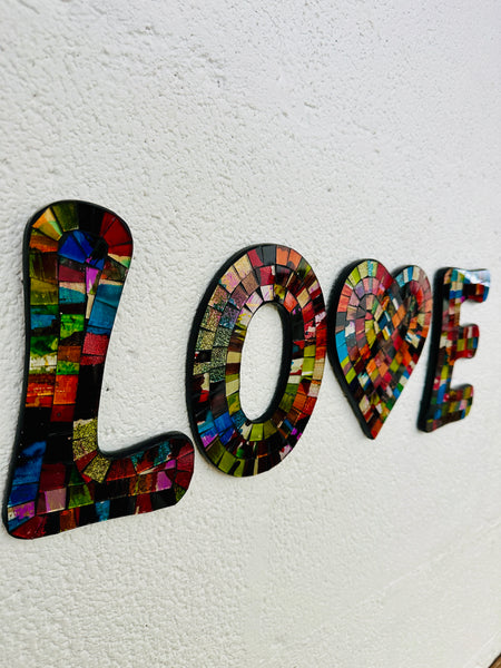 side view of mosaic love letters on white background