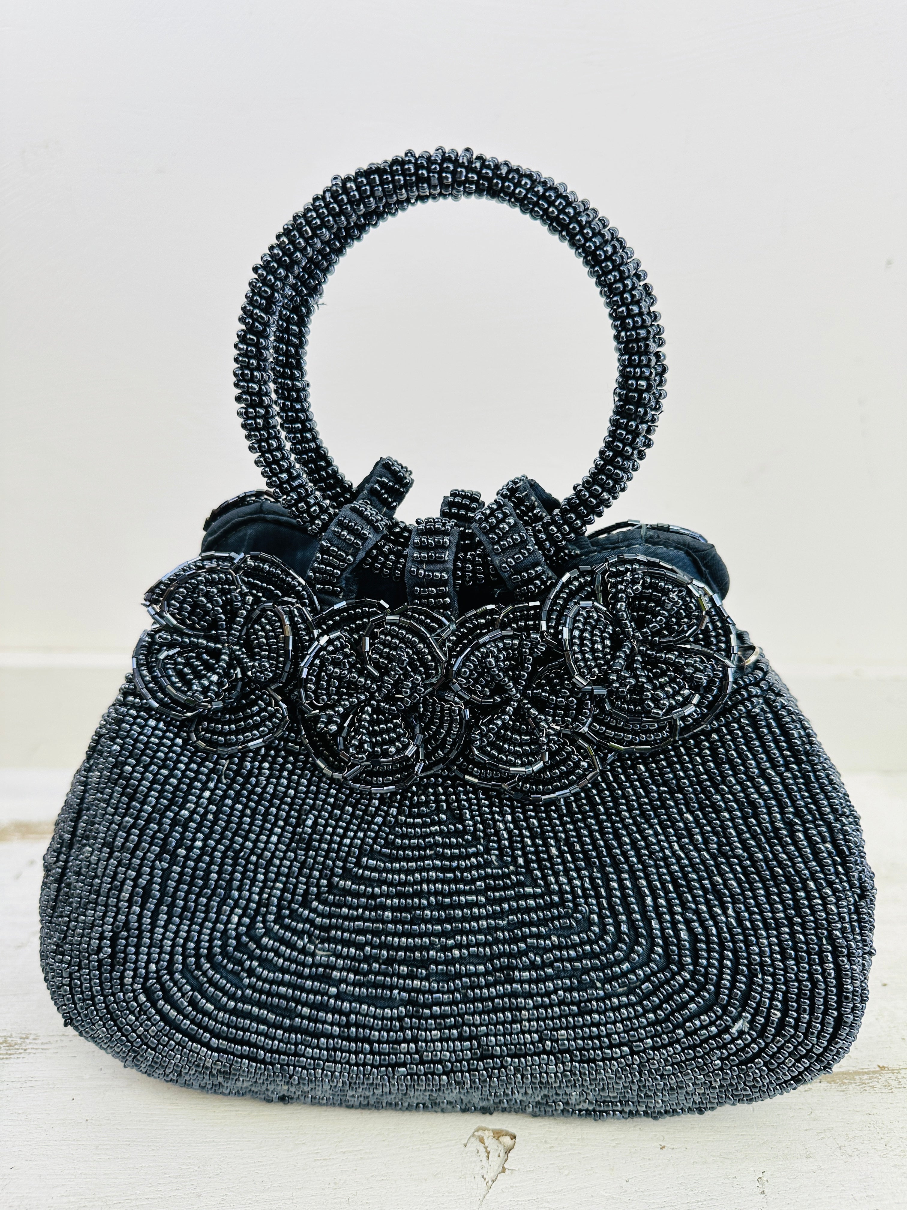 front view of beaded handbag with beaded flowers on bag