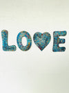 front view of mosaic love attached on wall