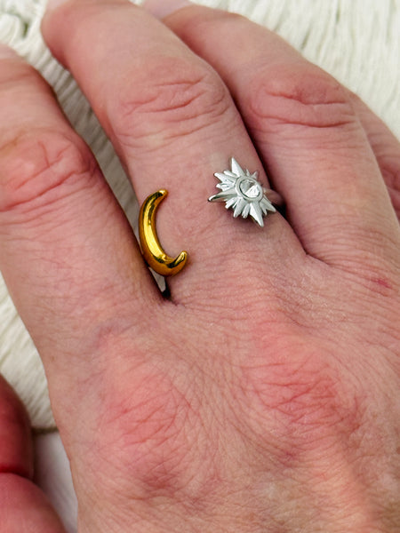 Moon and star open adjustable ring in gold and silver with crystal detail, displayed on a model.