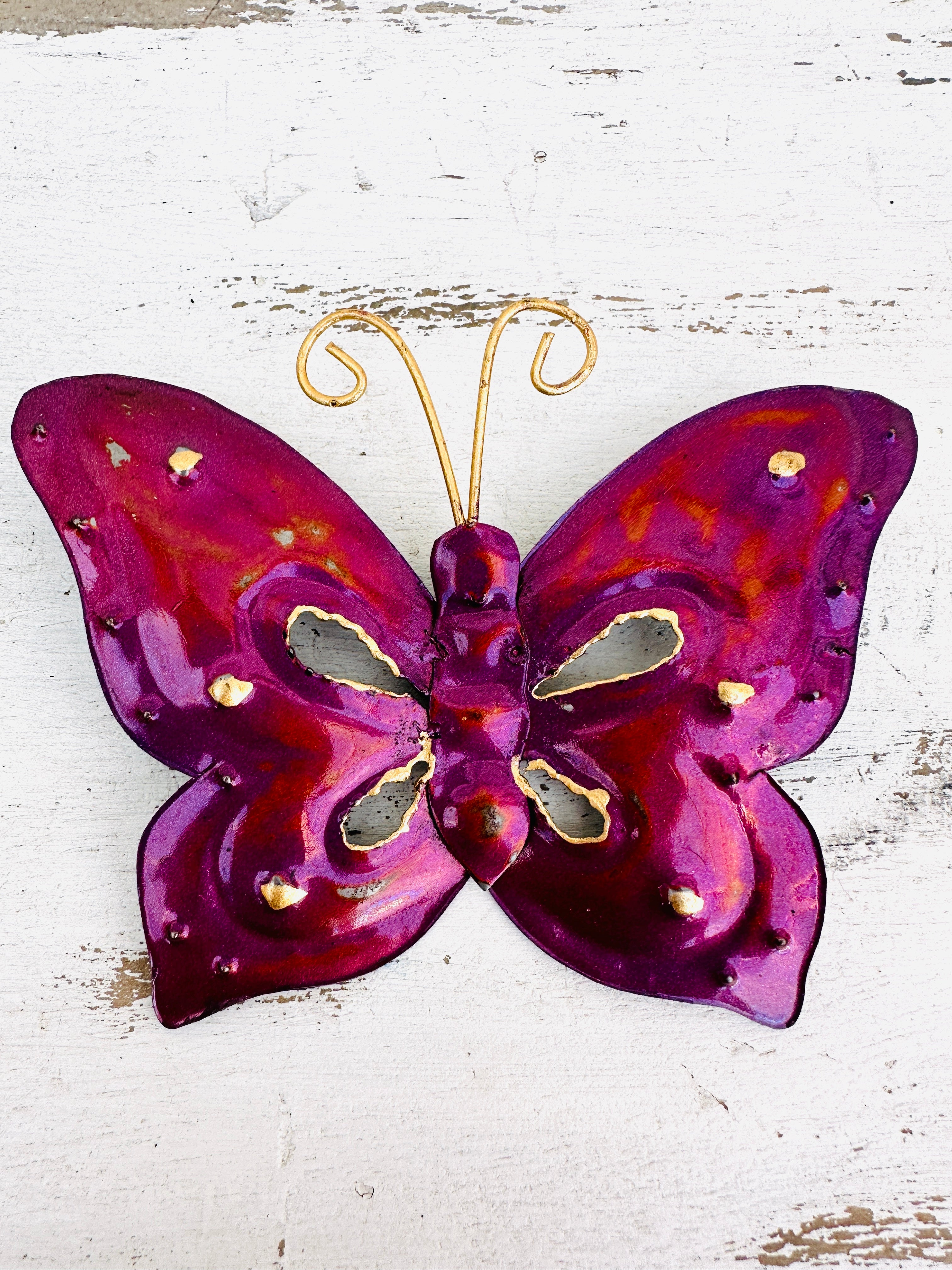 front view of metal butterfly in magenta