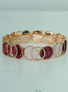 Elastic Aurea bracelet with rose-gold enamel circular design in gold-tone finish.