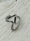 Minimalist abstract open band ring in polished silver tone with adjustable fit, displayed on a white background.