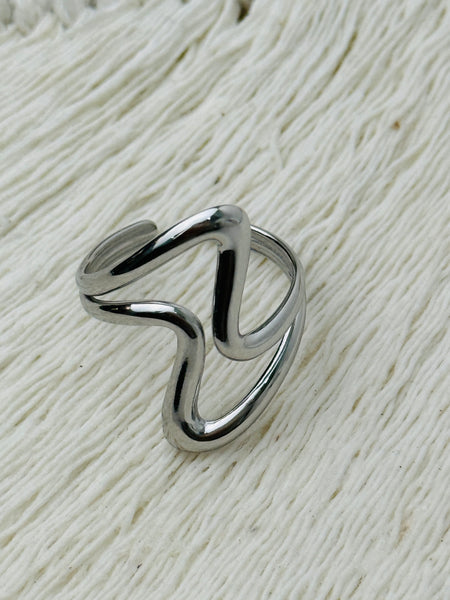 Minimalist abstract open band ring in polished silver tone with adjustable fit, displayed on a white background.