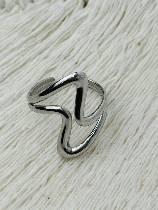 Minimalist abstract open band ring in polished silver tone with adjustable fit, displayed on a white background.