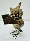 side view of metal owl caspar