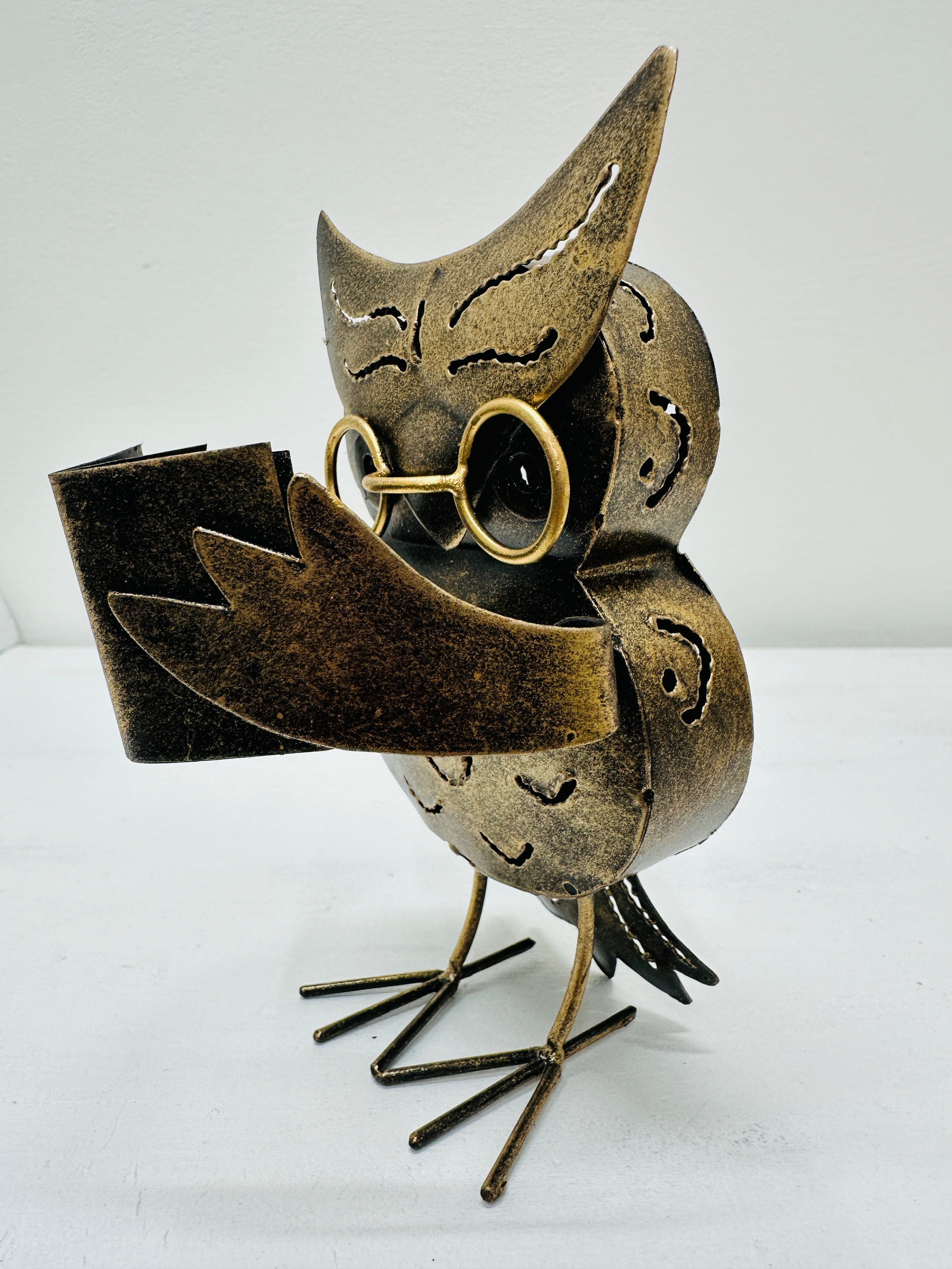 side view of metal owl caspar