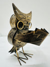side view of metal owl caspar