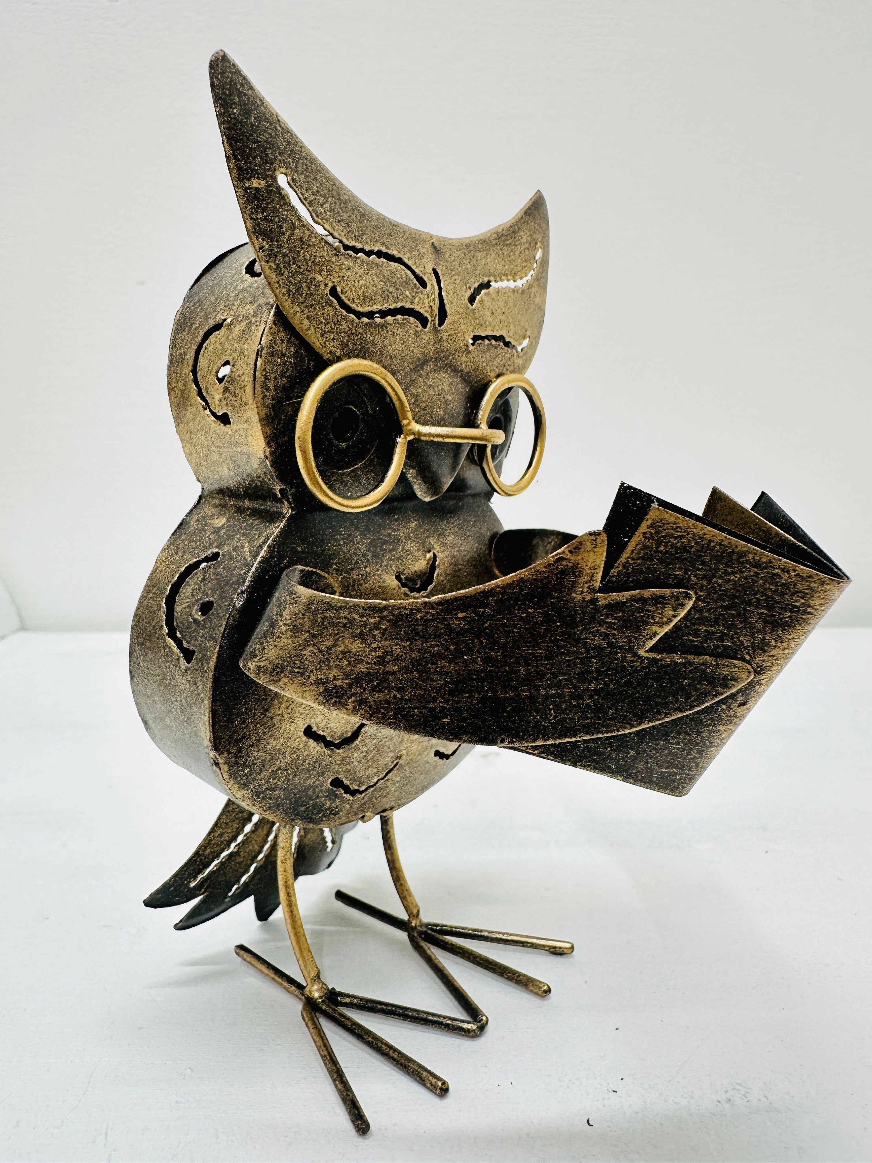 side view of metal owl caspar