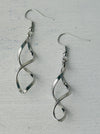 Elegant silver-tone twist earrings with a modern spiral design, displayed on a white background.