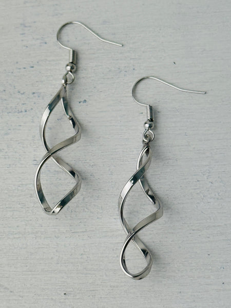 Elegant silver-tone twist earrings with a modern spiral design, displayed on a white background.