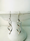 Elegant silver-tone twist earrings with a modern spiral design, displayed on a white background.