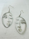 front of abstract portrait dangle earrings