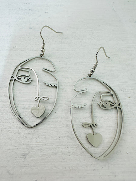 front of abstract portrait dangle earrings