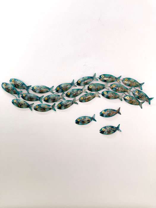 Display view of 18-piece aqua metal fish shoal wall art with 3 single on a white surface