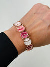 Elastic Aurea bracelet with rose-gold enamel circular design in gold-tone finish.