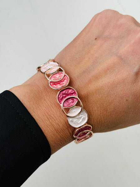 Elastic Aurea bracelet with rose-gold enamel circular design in gold-tone finish.