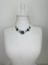 Aurea necklace with geometric enamel circles on a display mannequin.