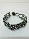 A silver bracelet with a combination of seed beads and gemstones, featuring an easy fastening button and loop.