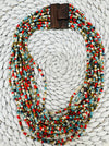 Bead statement waterfall style necklace with multicoloured seed beads and hand carved wood clasp., displayed on a white background.