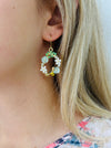 Bee and daisy, floral dangle earrings with enamel flowers, sparkling rhinestones, and gold-tone bee detail, displayed on a model.