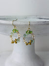 Bee and daisy, floral dangle earrings with enamel flowers, sparkling rhinestones, and gold-tone bee detail, displayed on a white background.