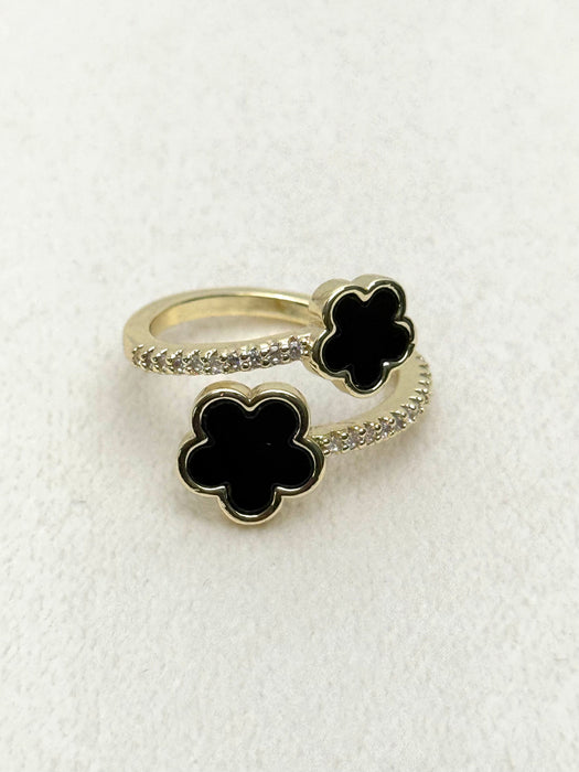 close-up of black clover open ring with crystal details in gold tone