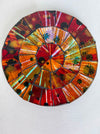 Round mosaic coaster with a colourful pattern on a white background