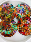 Set of colourful circular mosaic coasters on a white background