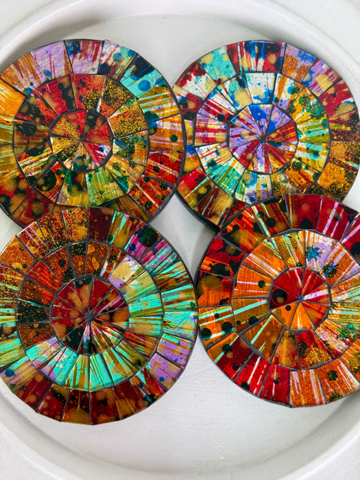 Set of colourful circular mosaic coasters on a white background