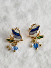 pair of cute enamel cat clip on earrings with pearl and blue crystal drops.