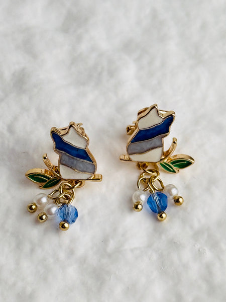 pair of cute enamel cat clip on earrings with pearl and blue crystal drops.